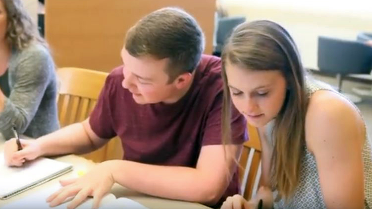 Two students working on classwork