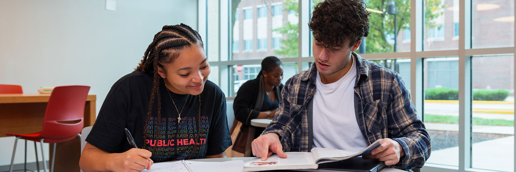 two public health students studying together in the health sciences building