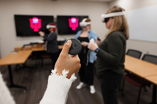 three individuals using virtual reality headsets during training