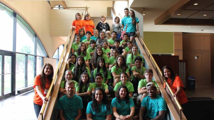 large group of students sitting on stairs at campus center